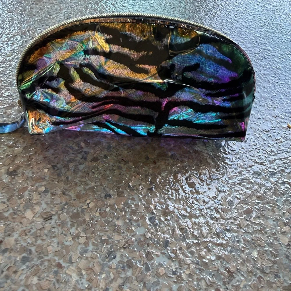 A iridescent zebra striped makeup bag